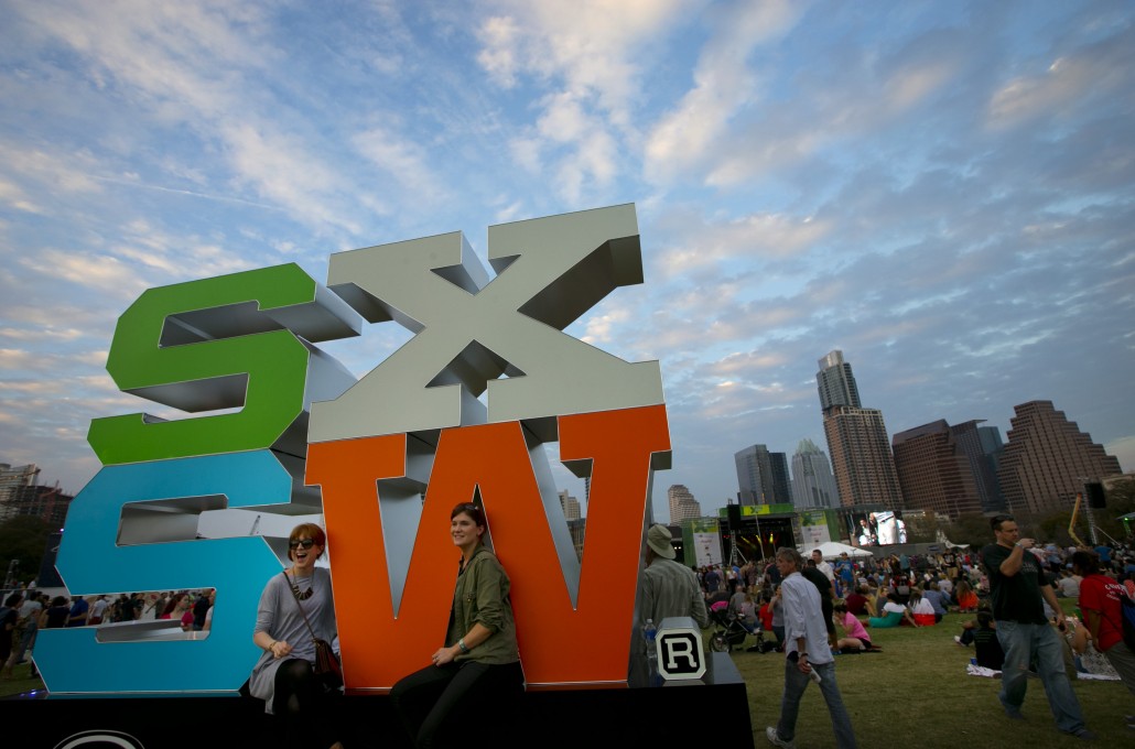 Laura Mac Darby, left, and Emer Ryam, both from Dublin, Ireland, attend the free concert at Auditorium Shores headlined by Spoon at SXSW on Thursday, March 19, 2015. (AP Photo/Austin American-Statesman, Jay Janner)
